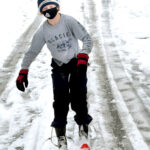 Maraid Johnson skis down a snowy street